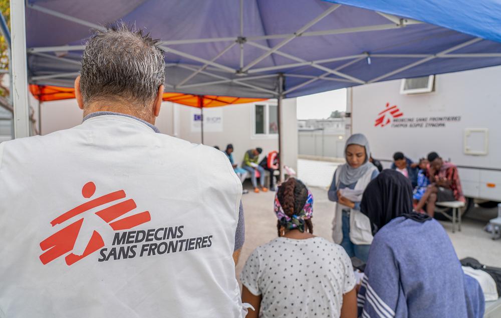 Medium shot of an MSF worker standing in the waiting area outside the mobile clinic in the Closed Control Access Centre in Zervou, Samos. 