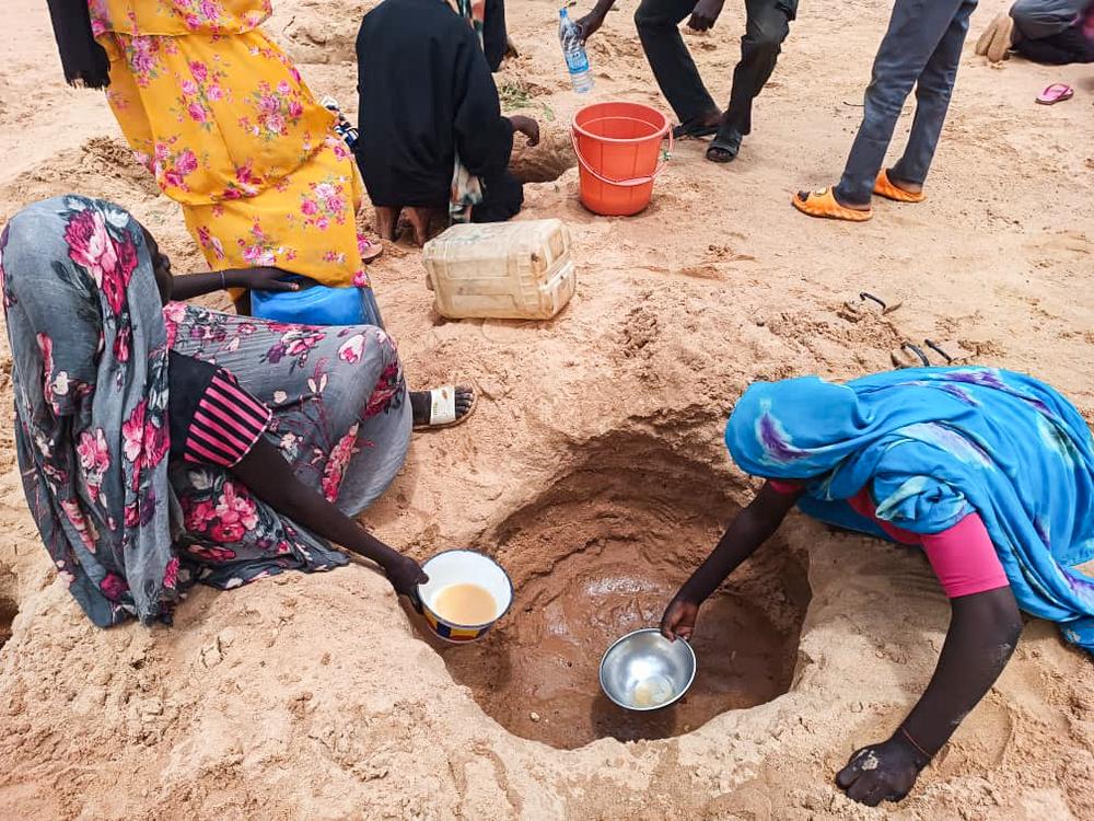 Sudanese refugees try to collect water from the wadi near the Ourang camp, as water distribution in the camps is scarce. August 2023 