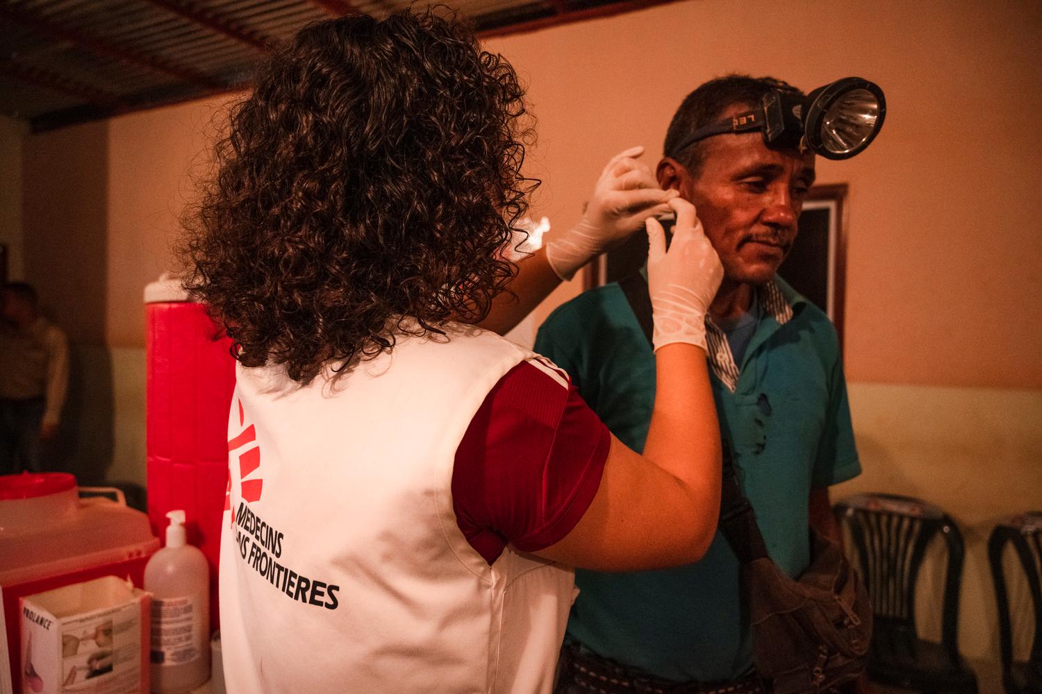 A MSF bioanalyst, takes a blood sample from 53-year-old Omar for a test to determine whether he has malaria. Bolivar, Venezuela, October 2019. 